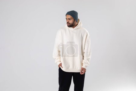 African American man in a knitted hat and white oversized hoodie. Mock-up.