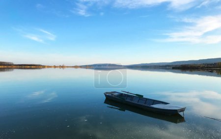 Photo for Serbian border with Romania on the Danube river coastline panorama and a small fishing boat - Royalty Free Image