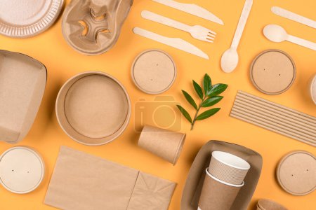 Photo for Eco-friendly paper utensils - sustainable food packaging over orange background. Street food paper packaging, recyclable paperware, zero waste packaging concept. Flat lay style - Royalty Free Image