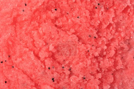 Foto de Sugar or salt body scrub texture. Pink red scrub - skin care product with fruit extract as cosmetic background with copy space. Macro photo - Imagen libre de derechos