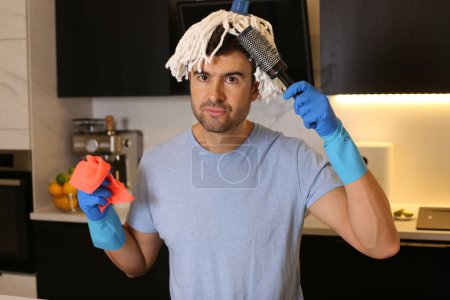 Photo for Portrait of handsome young man with mop on head at kitchen - Royalty Free Image