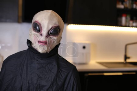 Photo for Close-up shot of person in alien mask at home - Royalty Free Image