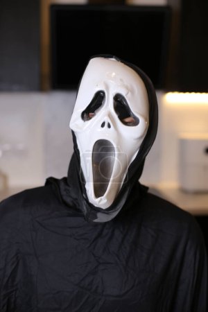 Téléchargez les photos : Gros plan de la personne en effrayante masque de cri à la maison - en image libre de droit