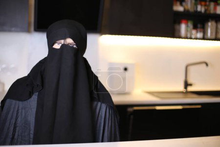 Photo for Close-up shot of person in Muslim woman mask at home - Royalty Free Image