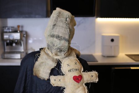 Photo for Close-up shot of person in scarecrow sack mask at home - Royalty Free Image
