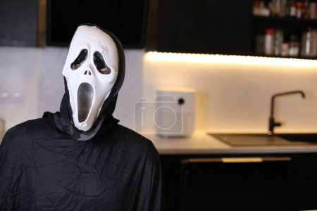 Photo for Close-up shot of person in scary scream mask at home - Royalty Free Image