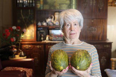 Photo for Close-up portrait of mature woman with melons at home - Royalty Free Image
