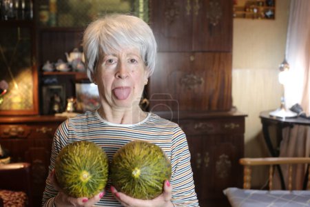 Photo for Close-up portrait of mature woman with melons at home - Royalty Free Image