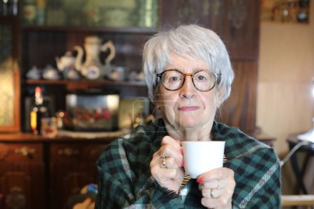 Photo for Close-up portrait of mature woman with with cup of hot drink at home - Royalty Free Image