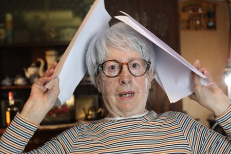 Photo for Close-up portrait of mature woman with papers at home - Royalty Free Image