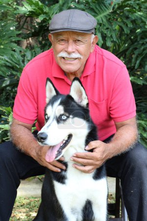 Photo for Close-up portrait of happy mature man with his husky dog in park - Royalty Free Image