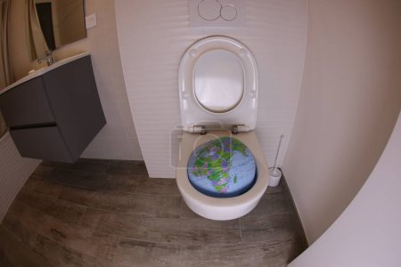 Photo for Wide angle shot of earth globe in toilet - Royalty Free Image