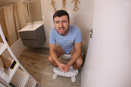 Photo for Wide angle shot of young man in toilet - Royalty Free Image