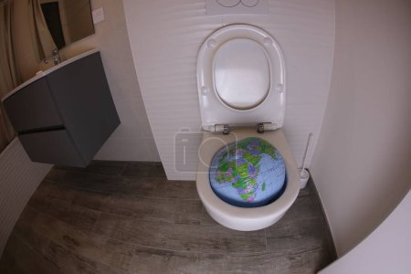 Photo for Wide angle shot of earth globe in toilet - Royalty Free Image