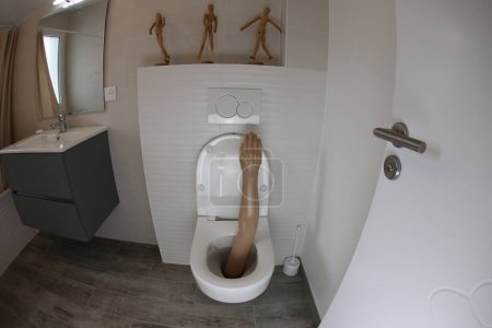 Photo for Wide angle shot of plastic arm sticking out of toilet - Royalty Free Image