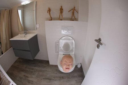 Photo for Wide angle shot of person sticking out of toilet, comedy concept - Royalty Free Image