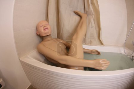 Photo for Wide angle shot of mannequin with crying baby head in bath tub - Royalty Free Image