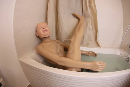 Photo for Wide angle shot of mannequin with crying baby head in bath tub - Royalty Free Image