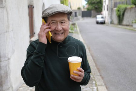 Photo for Portrait of handsome senior man in stylish clothes on city street - Royalty Free Image
