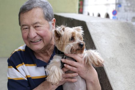 Photo for Close-up portrait of handsome senior man with his dog on street - Royalty Free Image
