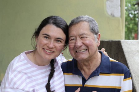 Photo for Close-up portrait of senior father with young daughter on street - Royalty Free Image