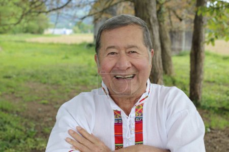 Photo for Portrait of handsome senior man in traditional Colombian clothes on nature - Royalty Free Image
