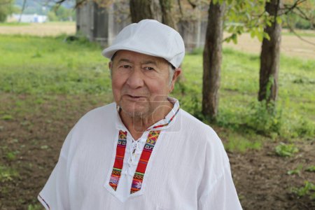 Photo for Portrait of handsome senior man in traditional Colombian clothes on nature - Royalty Free Image