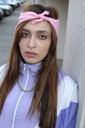 Photo for Portrait of stylish hipster woman wearing headband and piercing on urban background - Royalty Free Image