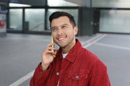 Photo for Portrait of handsome young man with smartphone on city street - Royalty Free Image