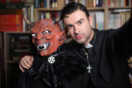 Téléchargez les photos : Portrait en gros plan de beau jeune prêtre avec démon intérieur - en image libre de droit