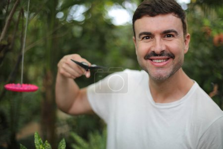Photo for Portrait of handsome young man carrying butterfly on his finger - Royalty Free Image
