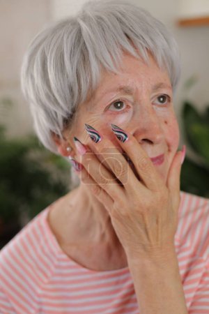 Photo for Portrait of beautiful mature grey haired woman with colorful nails at home - Royalty Free Image