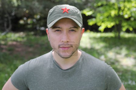 Man wearing revolutionary green hat with red star