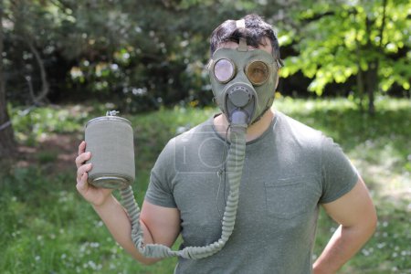 Photo for Man wearing vintage gas mask in natural setting - Royalty Free Image