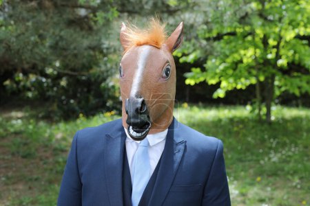 Photo for Businessman with a horse face on nature background - Royalty Free Image