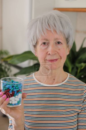 Photo for Senior woman holding too many pills - Royalty Free Image