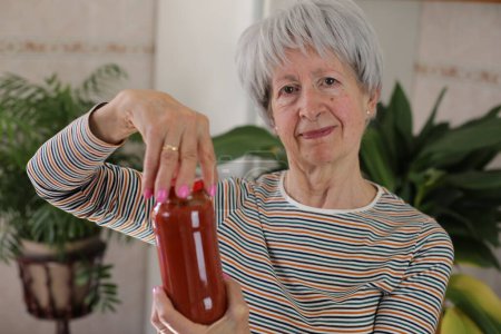 Senior woman trying to open a jar