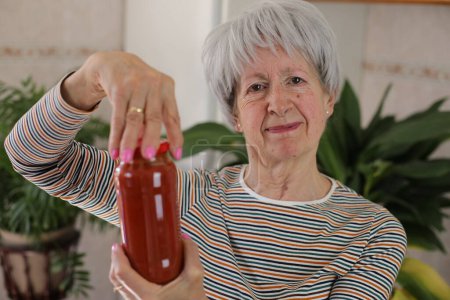 Senior woman trying to open a jar