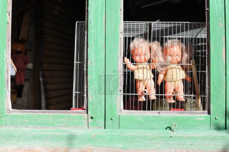 Photo for Spooky twin sister dolls looking through the window - Royalty Free Image