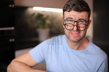 Photo for Man wearing three different types of eyeglasses simultaneously - Royalty Free Image