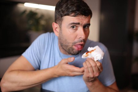 Man coughing saliva with blood on background, close up