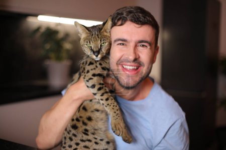 Exotic cat and his  male owner