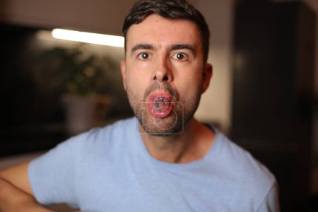 Photo for Man holding an ice cube between his lips - Royalty Free Image