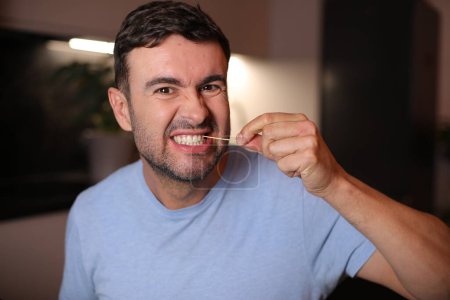 Photo for Man using a toothpick after lunch on background, close up - Royalty Free Image