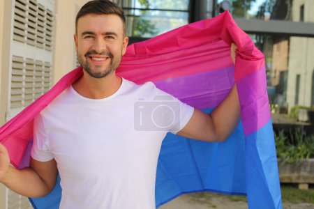 Proud man waving the bisexual flag