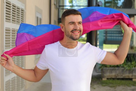 Proud man waving the bisexual flag