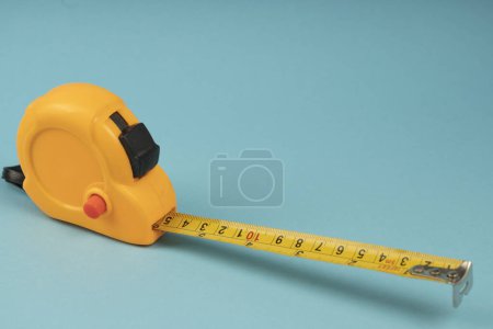 Photo for Yellow construction tape on a blue background - Royalty Free Image