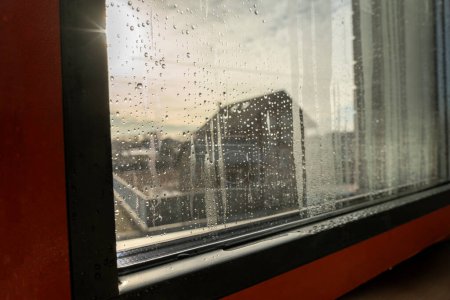 Photo for Close up of double glazed window condensation causes by excessive moisture in the house in winter occurs when the seal between panes is broken or desiccant inside the window. - Royalty Free Image