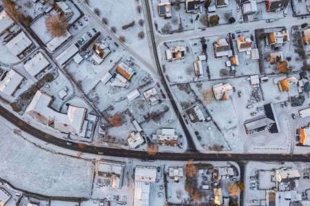 Foto de Vista aérea de un pequeño pueblo europeo en Suecia en invierno, muchas casas privadas. Clima nevado, puesta de sol. Luz solar cálida. - Imagen libre de derechos