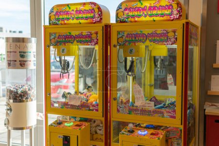 Photo for Sweden, Knislinge  September 16, 2022: Old vintage gaming machine in a shop. Claw crane. Candies and bubble gums machine. Big candy dispenser, gumball bank, gumball dispenser. Entertainment for kids. - Royalty Free Image